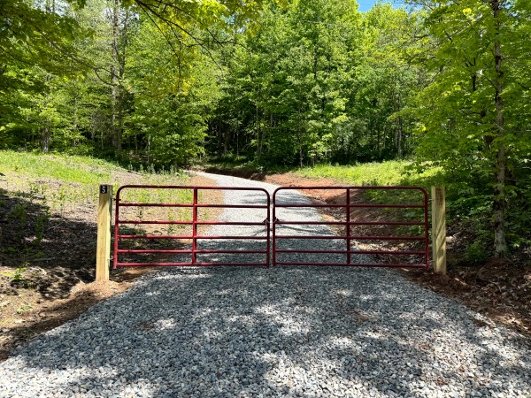 Gated gravel entrance to wooded acreage in Ohio